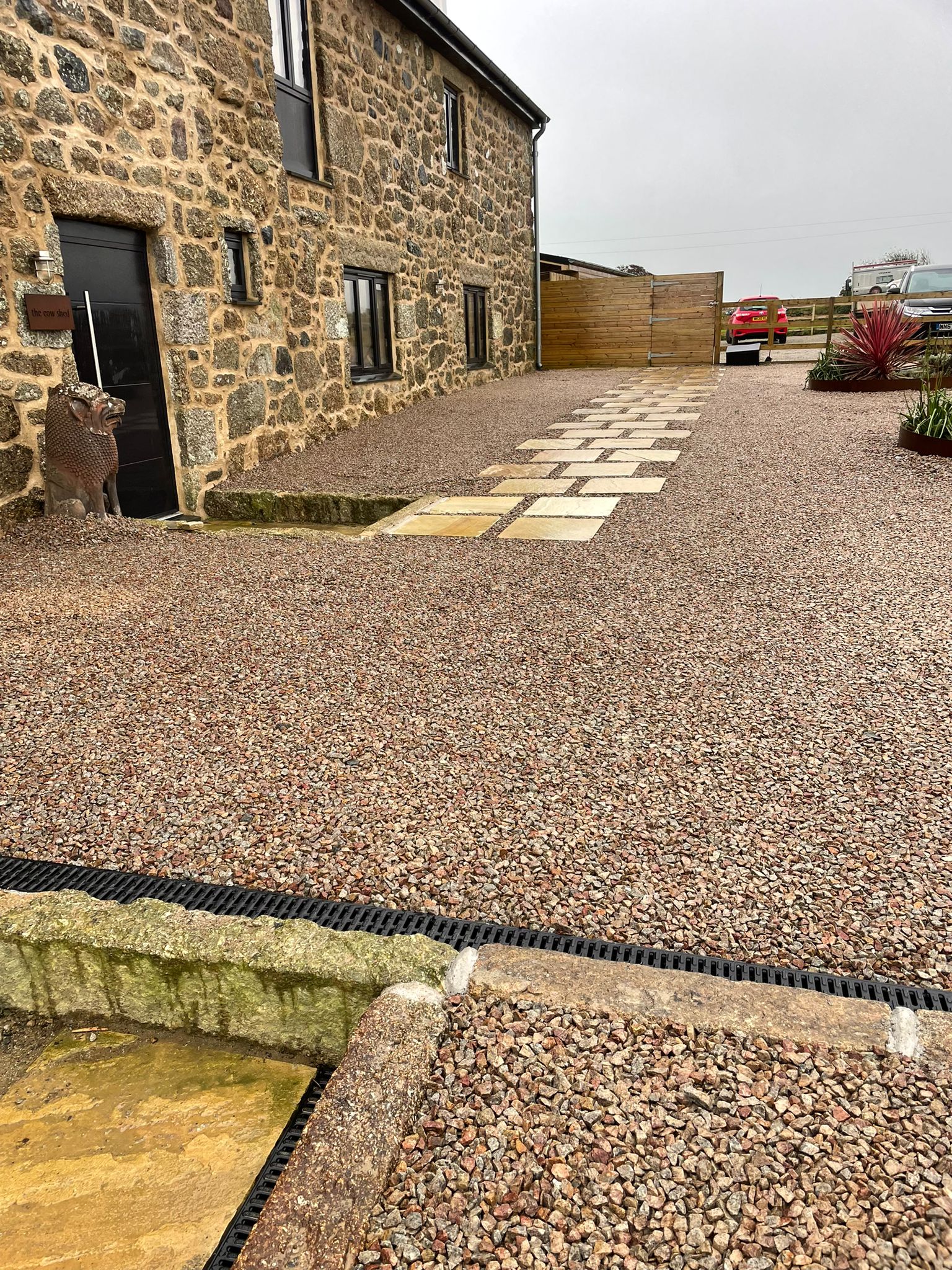Gravel driveway, paving and traditional stonework at a home in West Cornwall